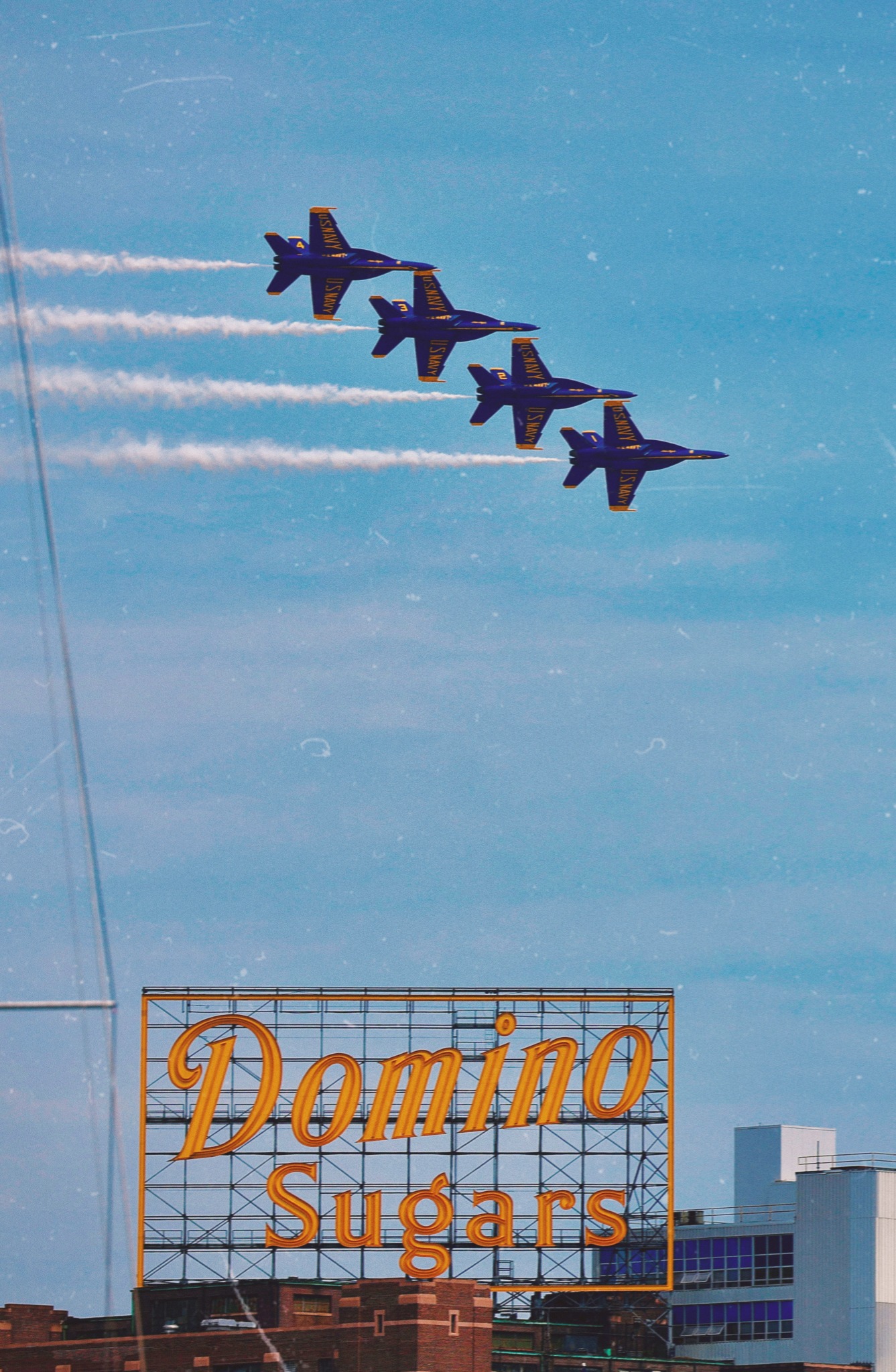 Blue Angels flying above the Domino Sugars sign in Baltimore